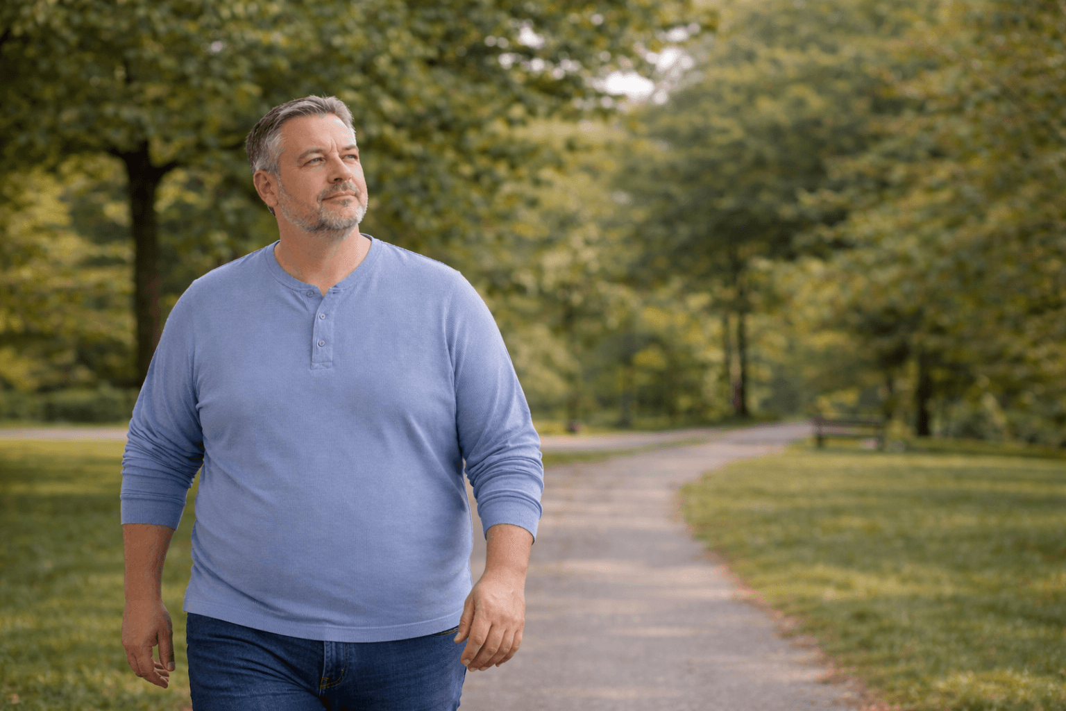 A person walking on a park path, suggesting long-term follow-through after bariatric surgery.